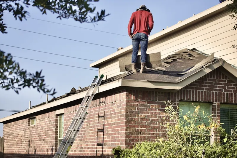 Professional roofer working on a residential roof in Wynnewood House